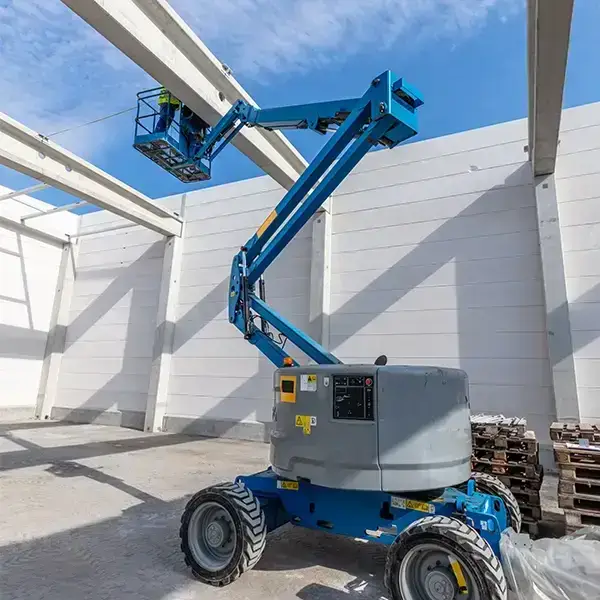 Cherry picker in use at a UK construction site for building maintenance and signage installation.