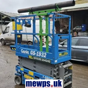 Close-up view of the MHA Universal Pipe Rack Attachment for Scissor Lifts, showing heavy-duty construction, securing straps, and precision adjustment holes.